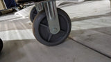 Close-up of a large castor wheel on the Dolphy hotel luggage trolley