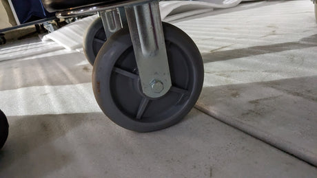 Close-up of a large castor wheel on the Dolphy hotel luggage trolley
