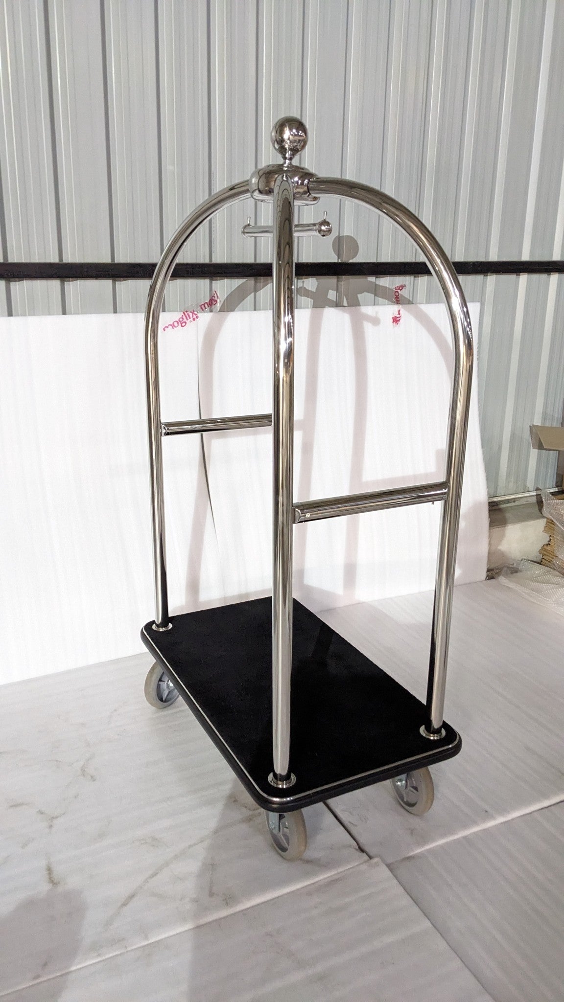 Dolphy hotel luggage trolley at an angle, showing the carpeted deck and hanging rail