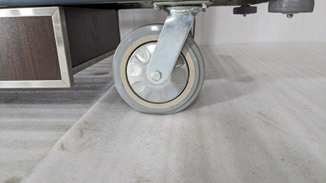 Close-up of a large castor wheel on the Dolphy housekeeping cart