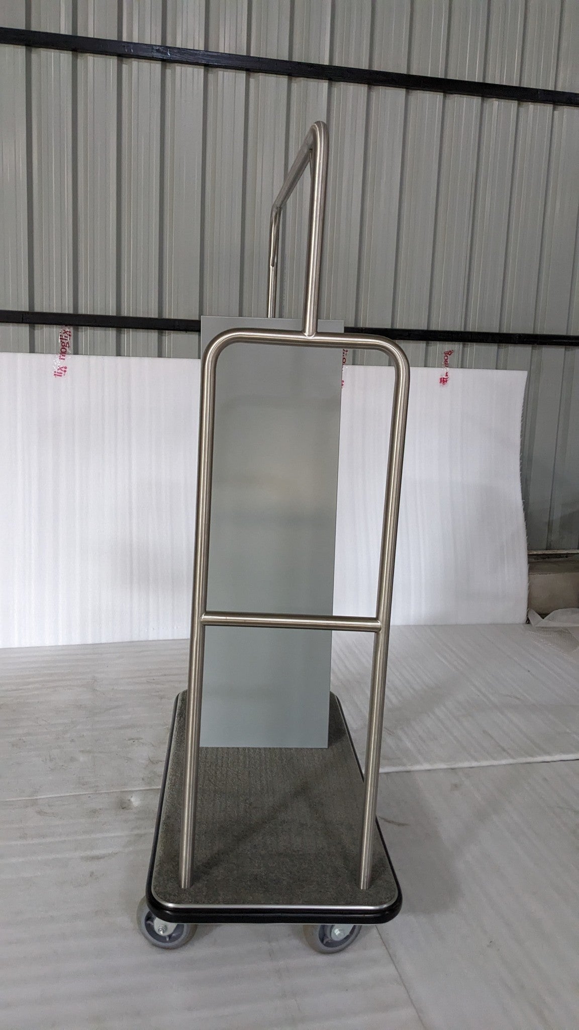 Dolphy laundry delivery trolley, end view showing the frosted panel and carpeted base