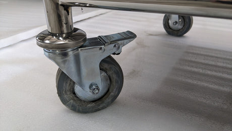 Close-up of a braked castor wheel on the Dolphy laundry cart