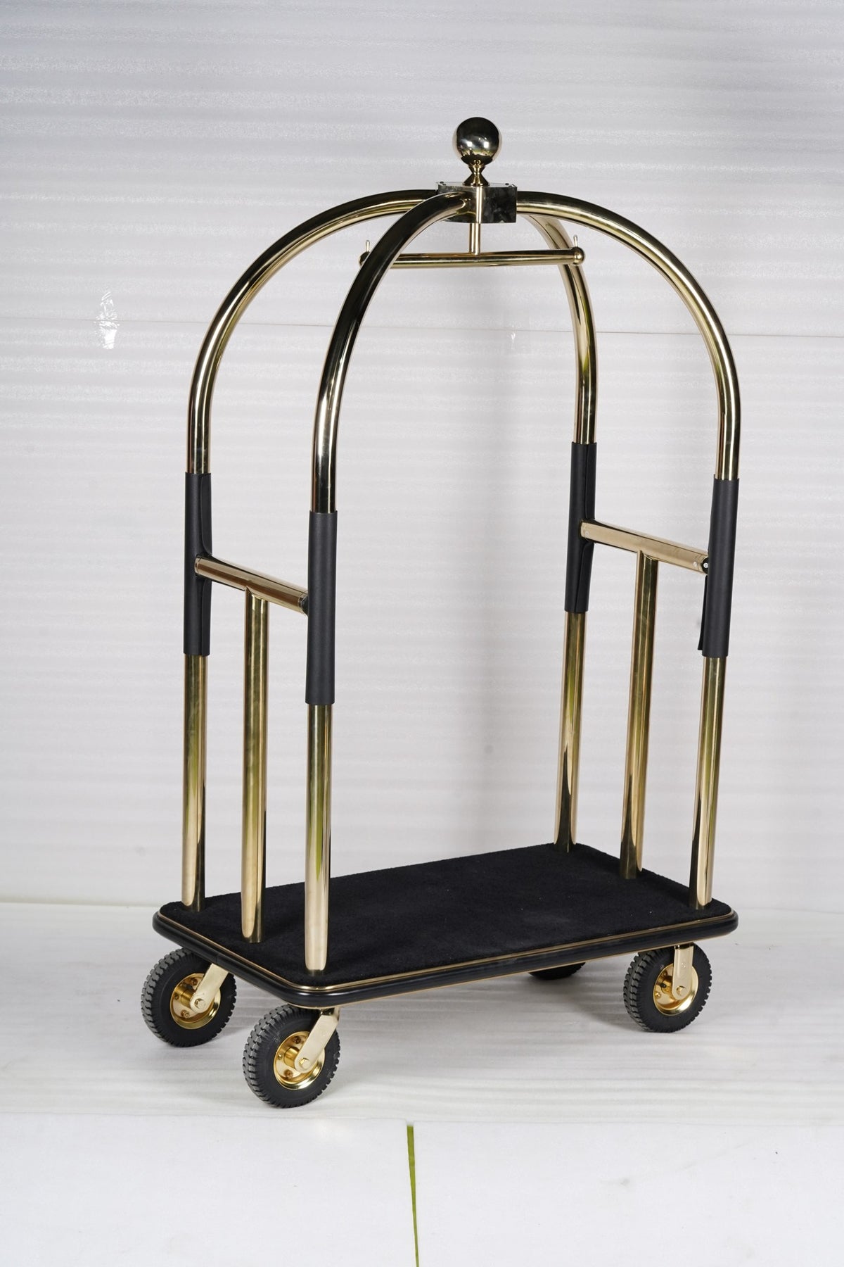 Dolphy gold and black luggage trolley at an angle