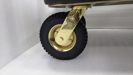 Close-up of a gold castor wheel on the Dolphy heavy-duty luggage trolley