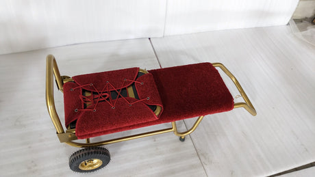 Dolphy foldable luggage trolley laid flat, showing the red carpeted deck