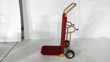 Dolphy gold and red foldable luggage trolley standing upright, side view