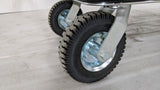 Close-up of the pneumatic wheels on the Dolphy platform luggage trolley