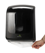 Hand pulling a paper towel from the Dolphy black multifold towel dispenser