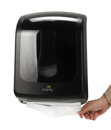 Hand pulling a paper towel from the Dolphy black multifold towel dispenser