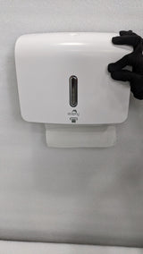 Dolphy white plaza paper towel dispenser mounted on a wall with a towel at the outlet