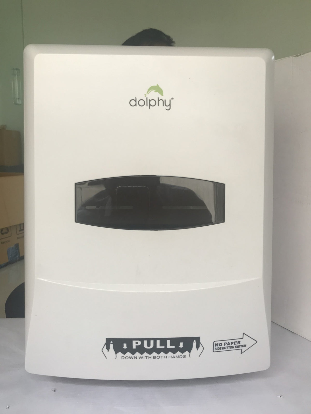 Dolphy auto-cut towel dispenser, front view showing the roll viewing window