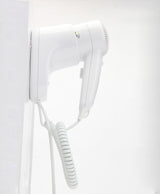 Dolphy white wall-mounted hair dryer seated in its wall holder, side view with coiled cord