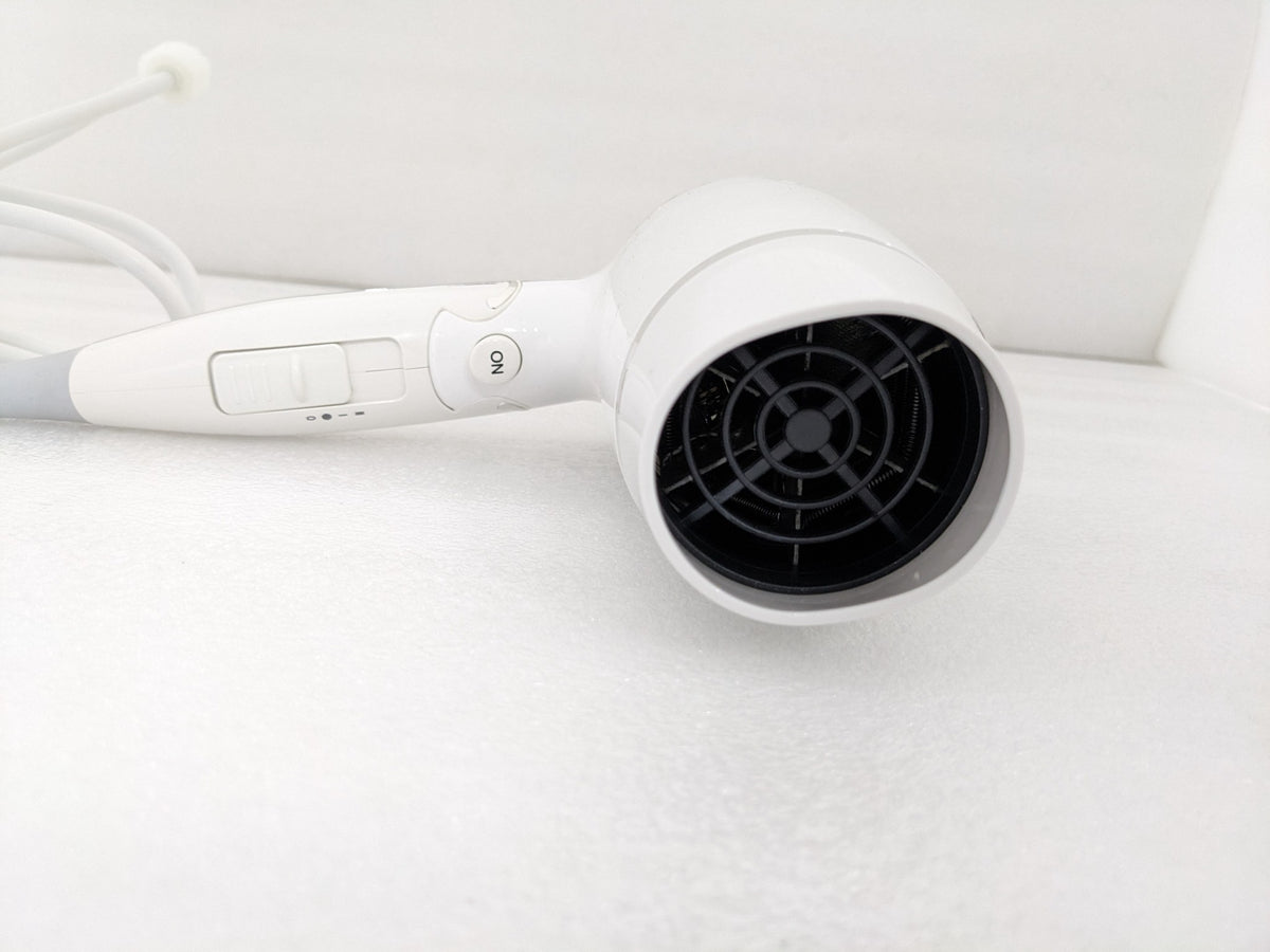 Dolphy white foldable 1800W hair dryer, close-up of the rear air intake and speed switch