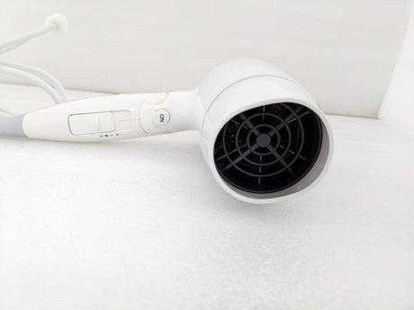 Dolphy white foldable 1800W hair dryer, close-up of the rear air intake and speed switch