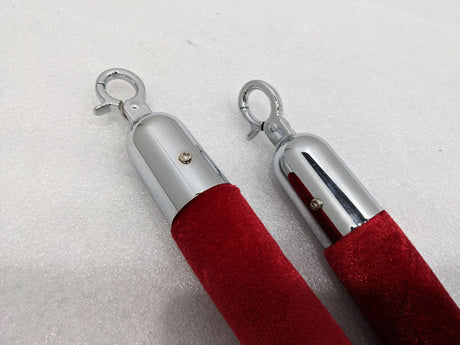 Close-up of the chrome end caps and snap hooks on the Dolphy red velvet rope