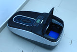 Dolphy shoe cover dispenser with the lid open, showing the cover cartridge bay