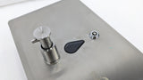 Close-up of the push button, window and key lock on the Dolphy recessed dispenser