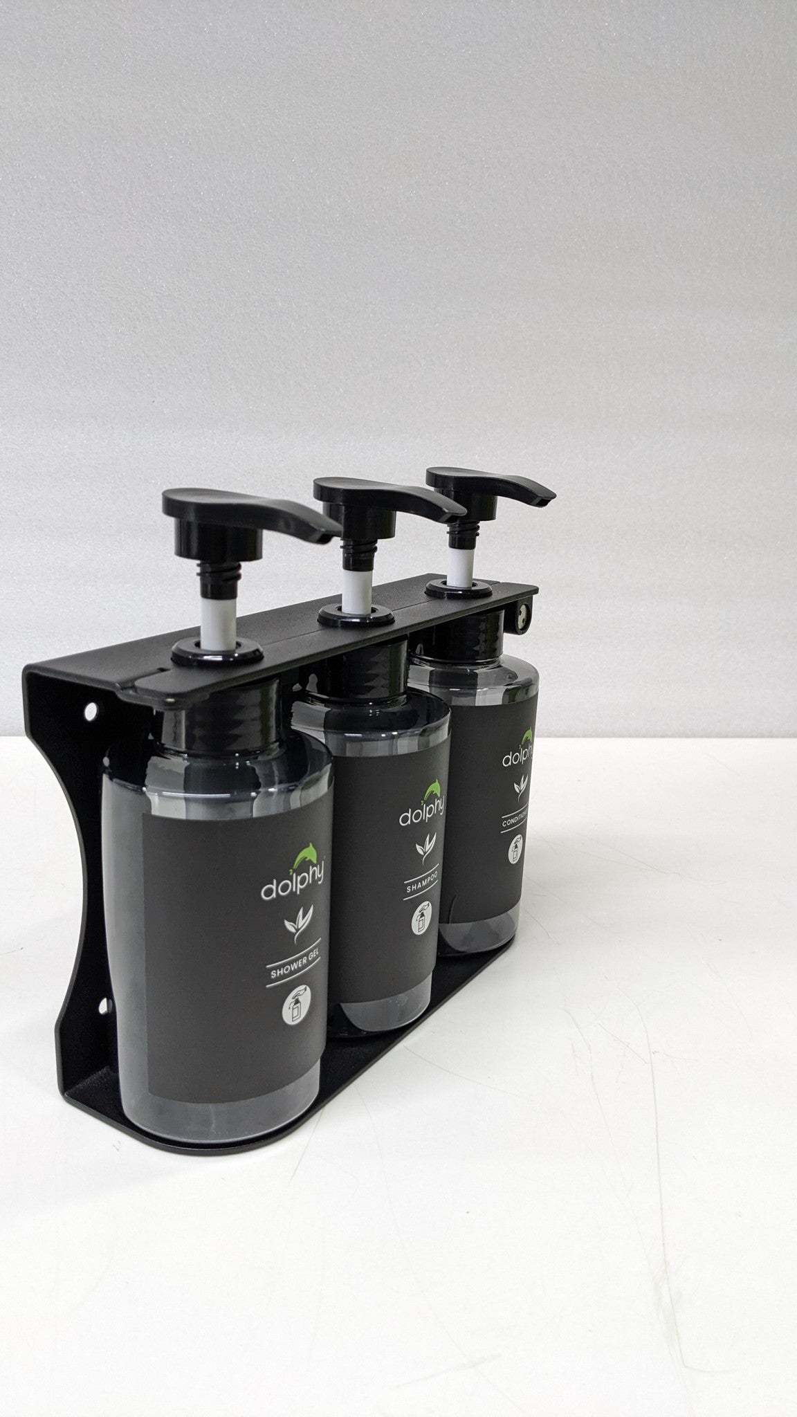 Dolphy triple pump dispenser in its bracket, side angle