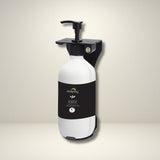 Dolphy white pump soap bottle in a black wall bracket, shown on a wall