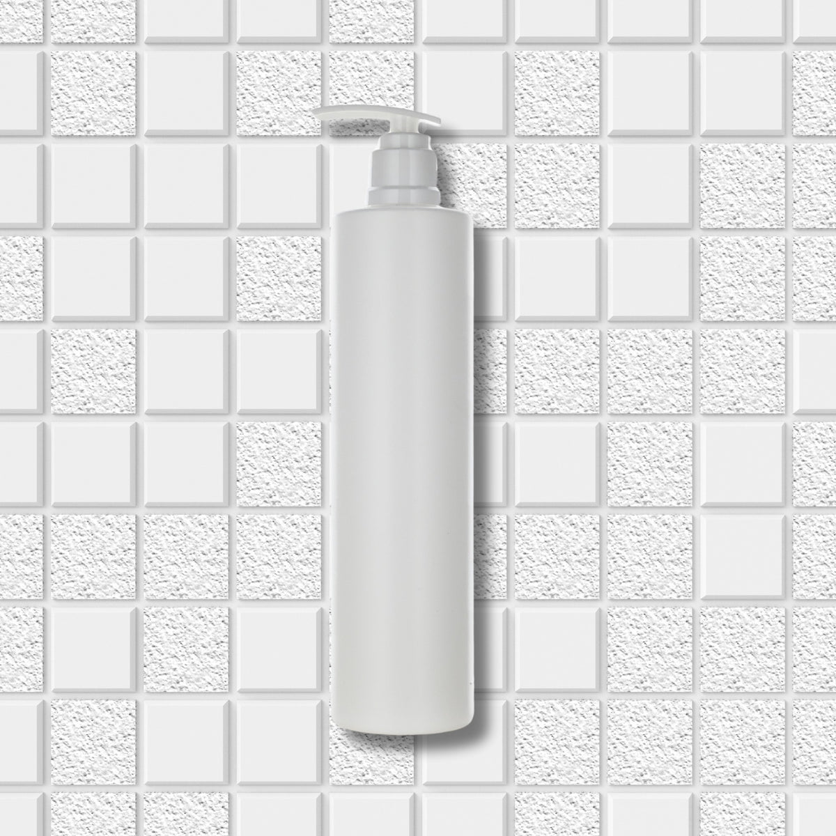 Dolphy white pump soap bottle shown against a white tiled wall