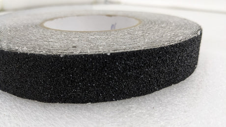 Close-up of the coarse grit edge of a Dolphy black anti-skid tape roll