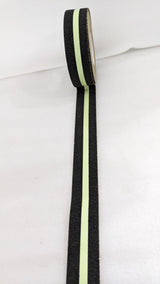 Dolphy glow stripe anti-skid tape unrolled, showing the gritty black edges and luminous centre