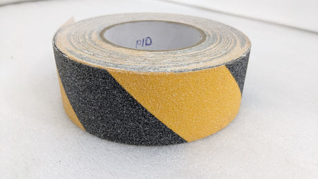 Dolphy black and yellow anti-skid tape roll, close-up of the gritty surface