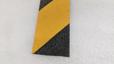 Close-up of the diagonal black and yellow stripes on Dolphy anti-skid tape