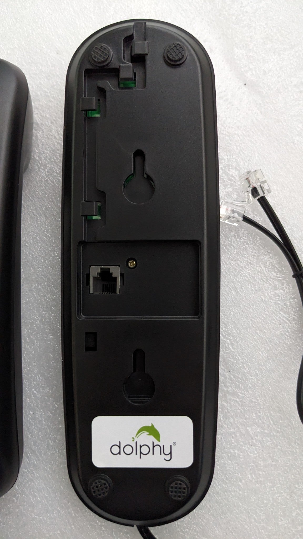 Back of the Dolphy telephone base showing keyhole wall-mount slots and the phone line socket