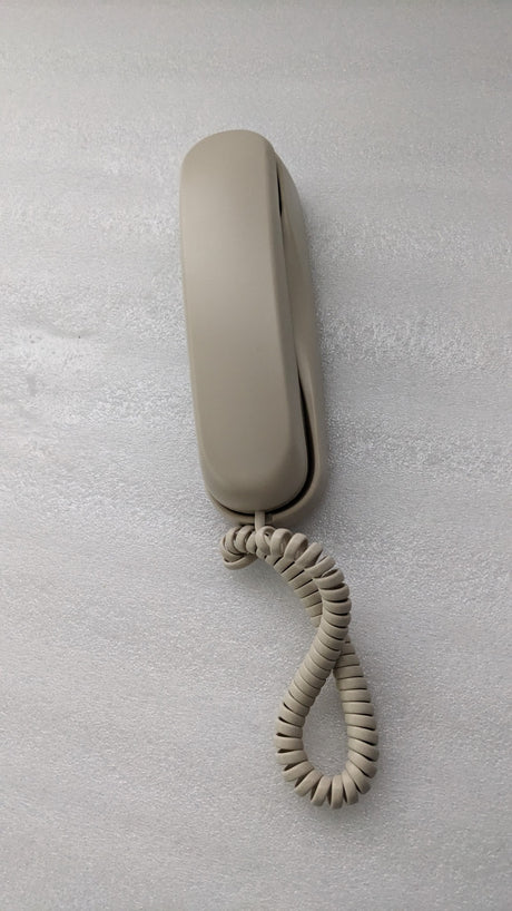 Dolphy ivory slimline telephone with the handset on its base