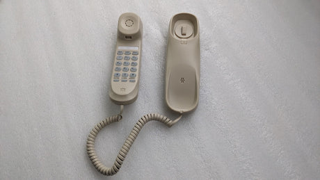 Dolphy ivory slimline telephone: handset with keypad beside its base, coiled cord