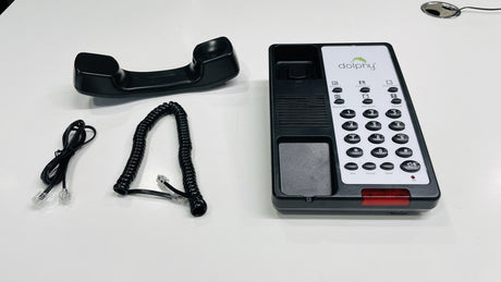 Dolphy black telephone base, handset, coiled cord and line cord laid out