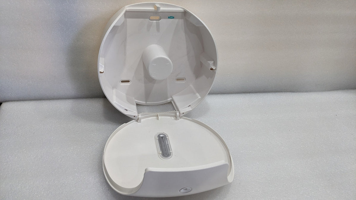 Dolphy jumbo roll dispenser opened, showing the roll spindle