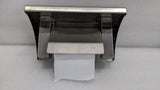 Underside of the Dolphy roll holder shelf showing the roll spindle and cover