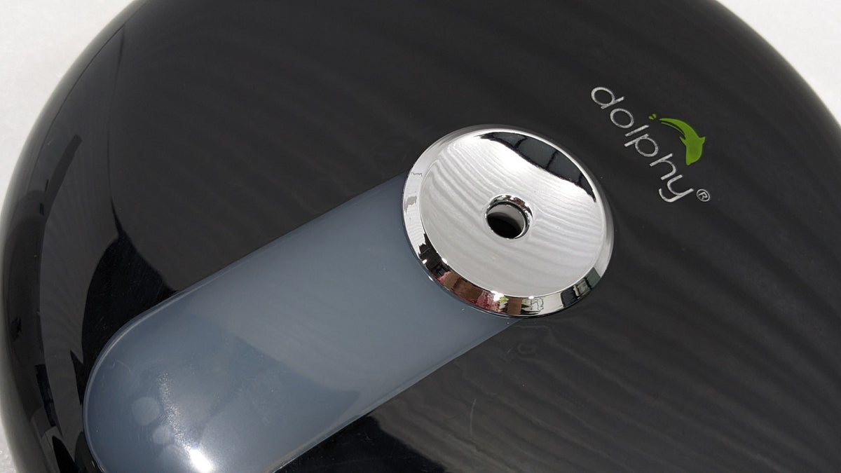 Close-up of the chrome centre-pull outlet on the Dolphy black dispenser