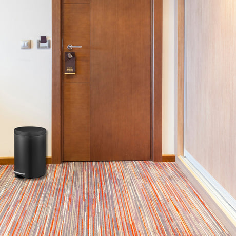 Dolphy 5L black pedal bin beside a hotel room door
