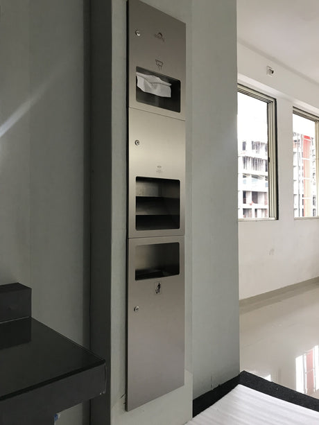 Dolphy 3-in-1 recessed washroom panel installed in a wall: towel dispenser, hand dryer and bin