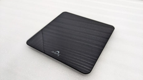 Dolphy black digital scale at an angle, showing the slim tempered glass platform