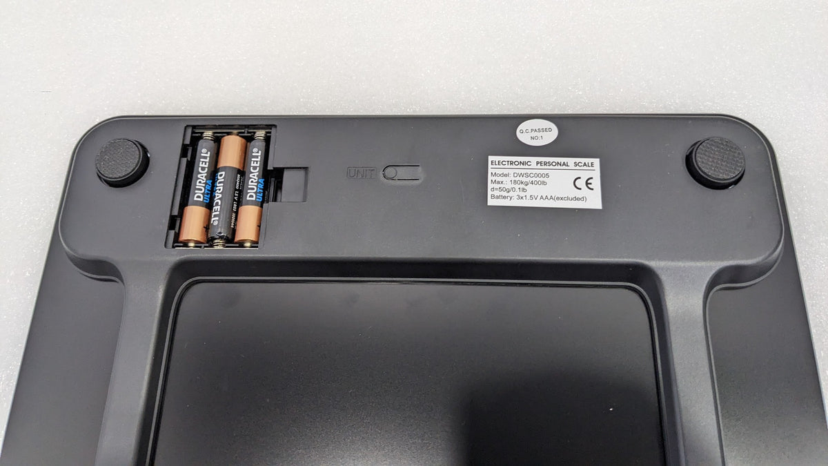 Underside of the Dolphy black scale showing the battery compartment and feet