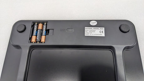 Underside of the Dolphy black scale showing the battery compartment and feet