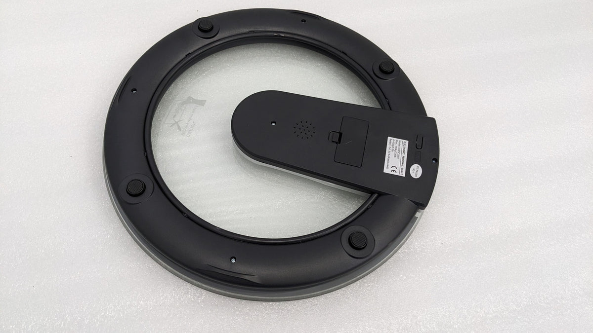 Underside of the Dolphy round glass scale showing the battery cover and feet